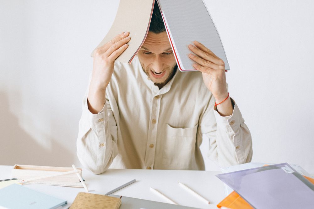 An overworked person at a desk, illustrating the toll of industries that don't put people first